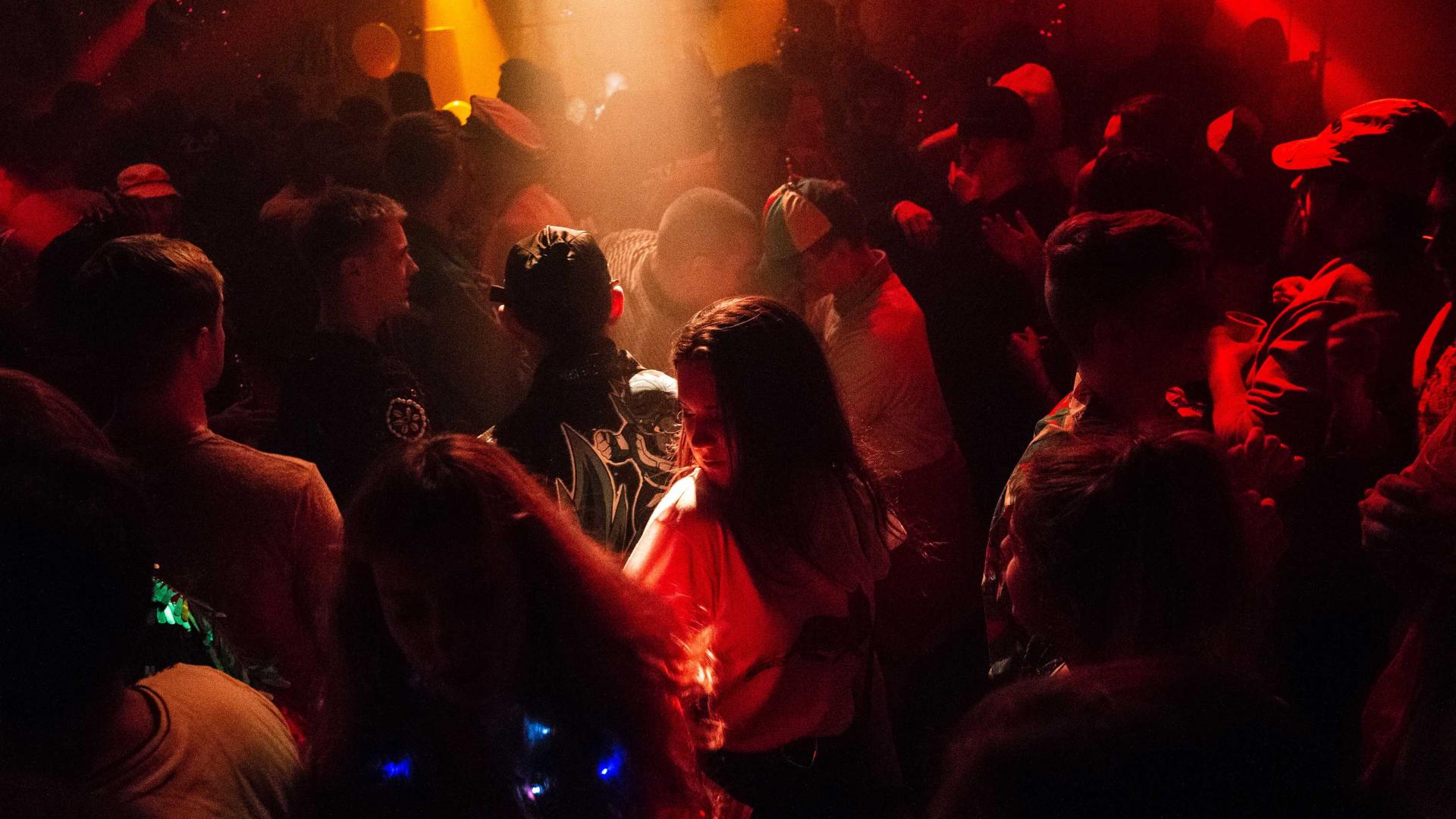 Dansende mensen in de club met rood en geel licht