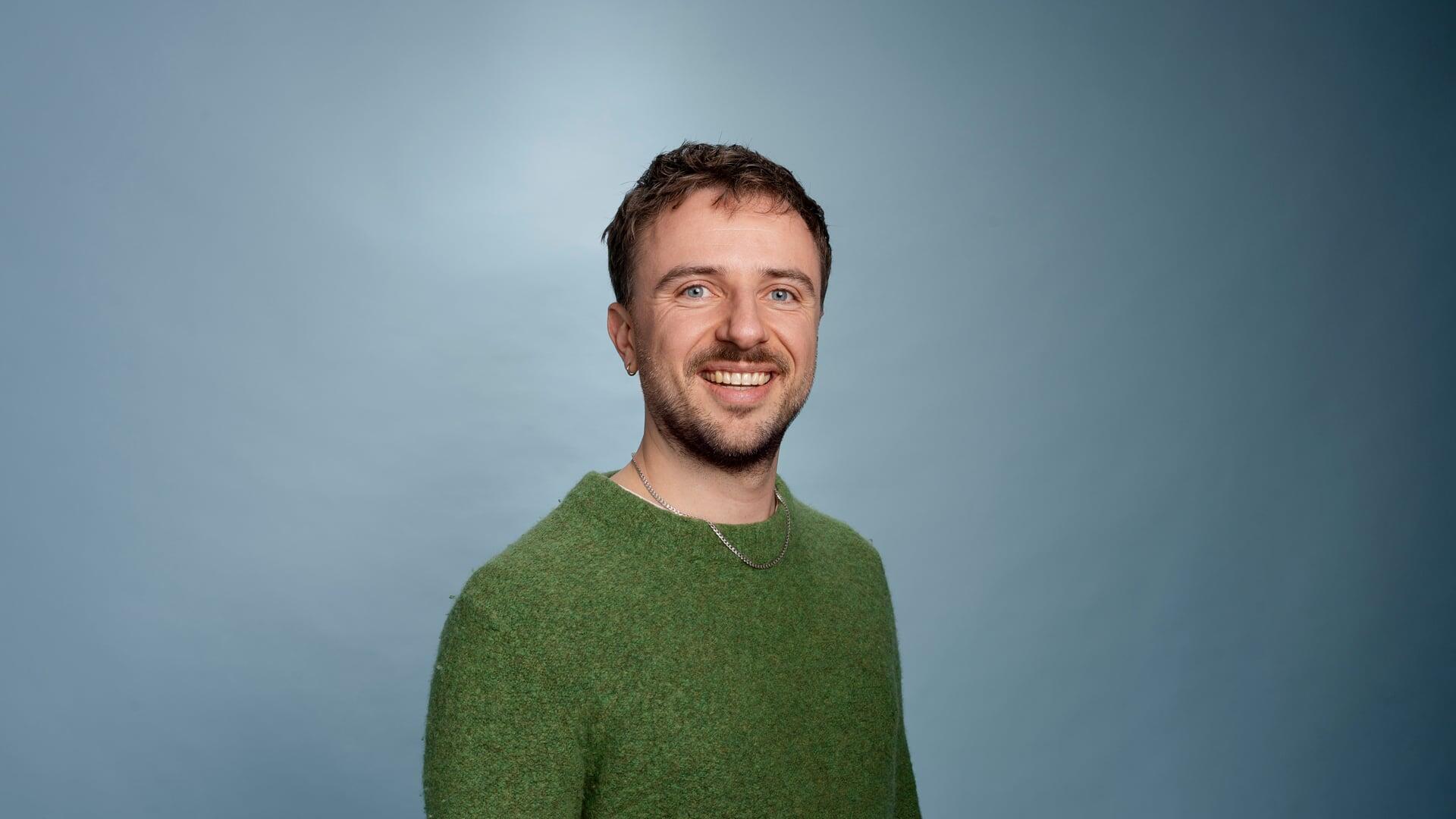 Thomas kijkt lachend de camera in